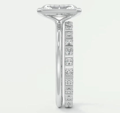 18k white gold diamond engagement ring with a princess cut center stone and channel set side stones.
