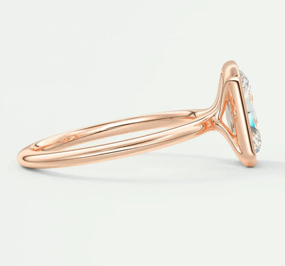 18k rose gold engagement ring with a central turquoise stone and diamond accents.